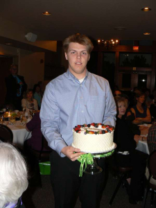Nathan Makarenko 'parading' a dessert for the dessert auction